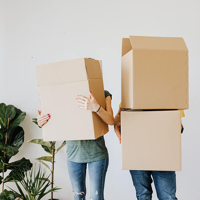 Couple moving holding moving boxes