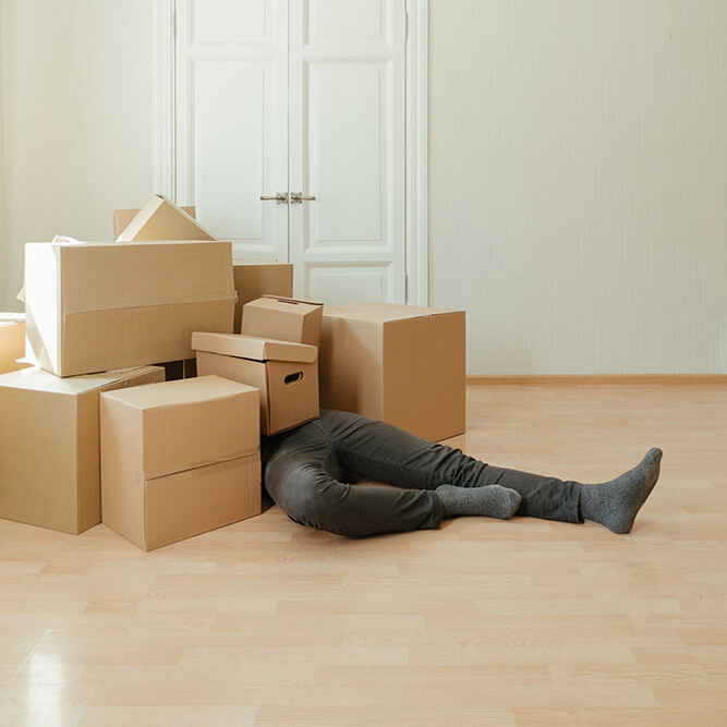 Person under moving boxes