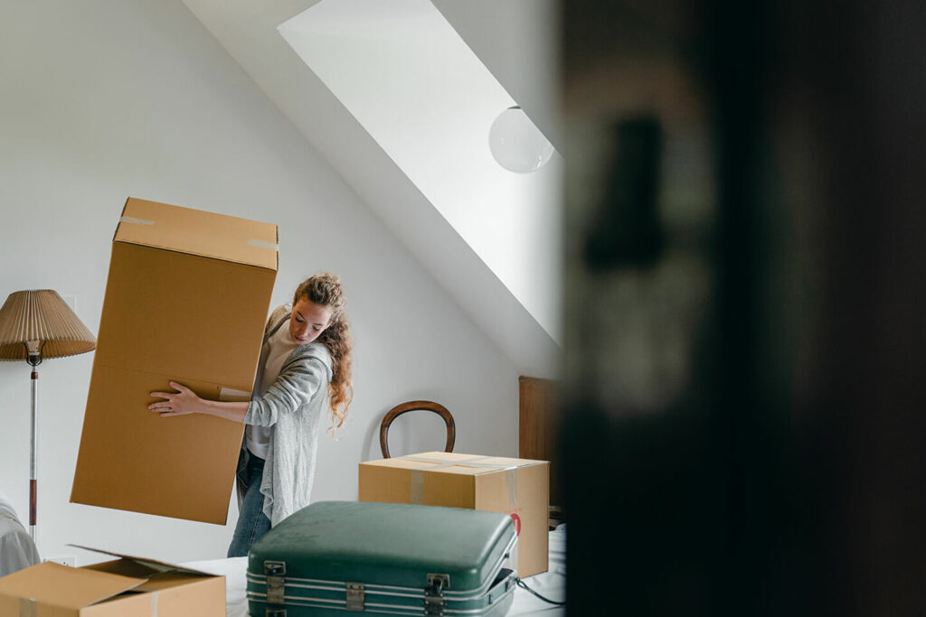 Woman in a NYC apartment moving boxes