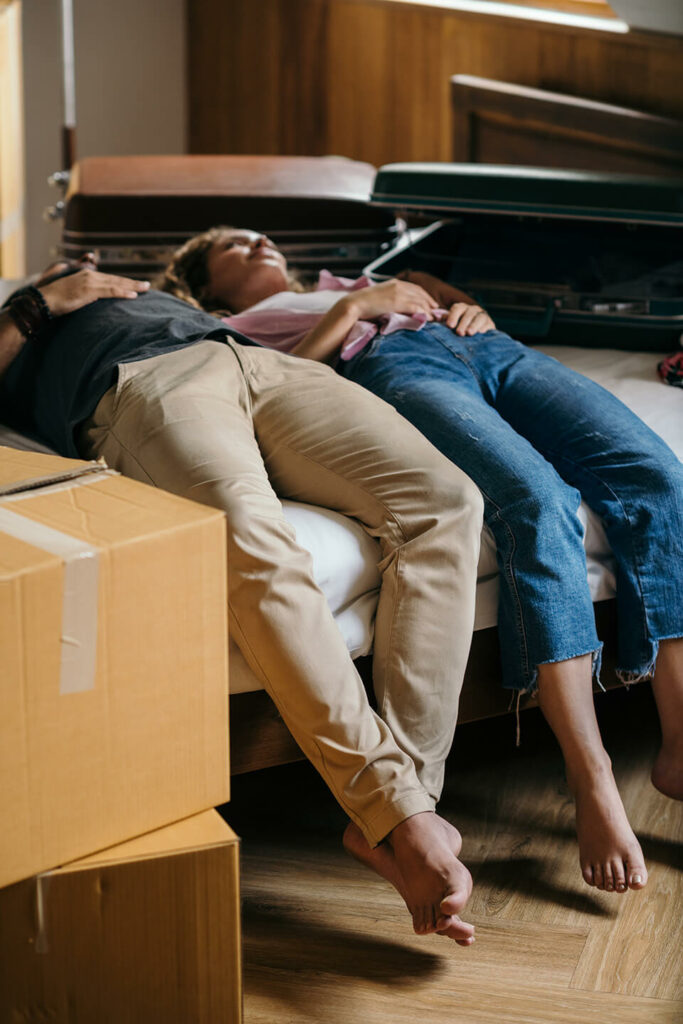 A couple tired after organizing a move