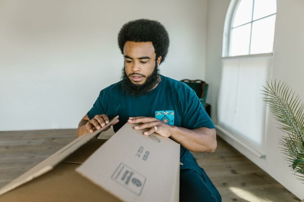 Man packing moving box