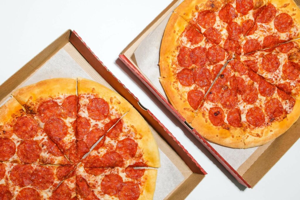 Two pepperoni pizzas in boxes